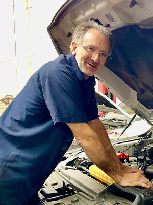 Barry Miller working on vehicle's engine | Innovative Auto Works