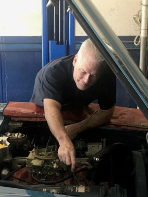 Mike Aldana working on vehicle's engine | Innovative Auto Works